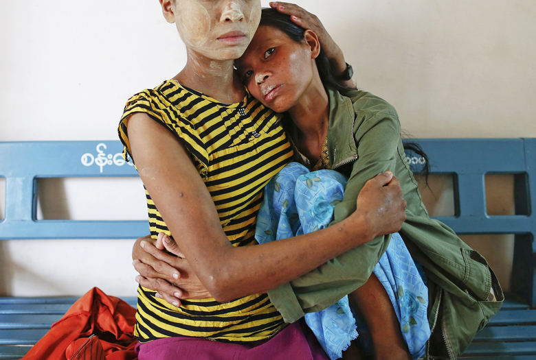 Mye Nyo, right, is comforted by Thi Darwin at a Catholic-run hospice for HIV/AIDS patients in Myitkyina, the capital of Myanmar’s Kachin, in this July 7, 2013 file photo. While the number of cases of HIV/AIDS has fallen globally, they have risen significantly in Indonesia. (Reuters Photo/Damir Sagolj)