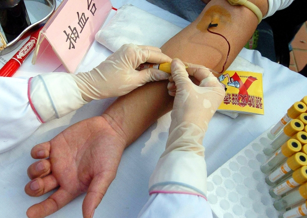 A Chinese man gets a free HIV test during a World AIDS Day public awareness campaign. Photograph by: STR , AFP/Getty Images