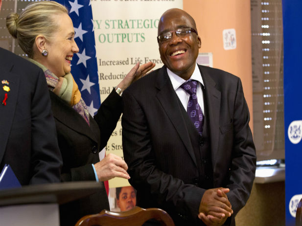 U.S. Secretary of State Hillary Clinton talks with South Africa's Health Minister Aaron Motsoaledi after attending a PEPFAR (U.S. President's Emergency Plan for AIDS Relief) Transition Signing, at Delft South Clinic in Delft South, a suburb of Cape Town, August 8, 2012. (Jacquelyn Martin-Pool/Courtesy Reuters) 